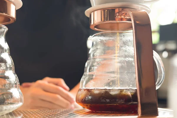 Barista wait drip coffee dropping into a beaker (Drip coffee brewing)