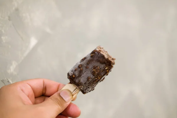 Ice cream bar vanilla covered with chocolate and nut