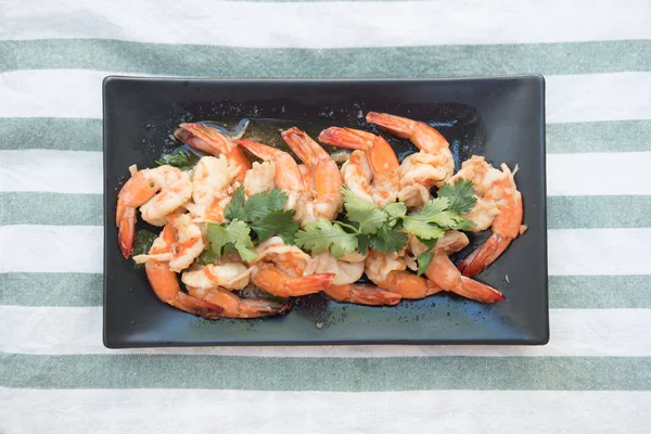 Boiled shrimp fried with sweet sauce on black tray — Stock Photo, Image