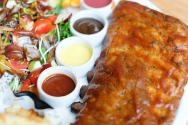 Barbekü sosu ve meyve salatası ile kavrulmuş domuz kaburga