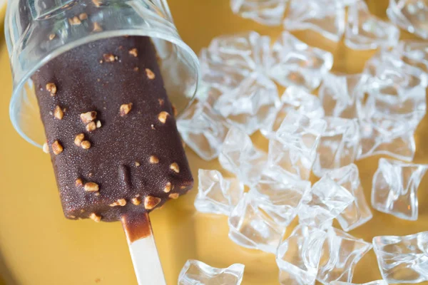 Ice cream bar covered with chocolate and almonds