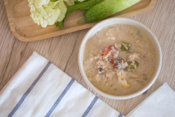 Crab dip with coconut milk and vegetables in bowl