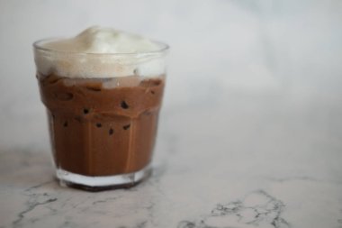 Mermer arka planda krem şanti ile koyu çikolata içecek 