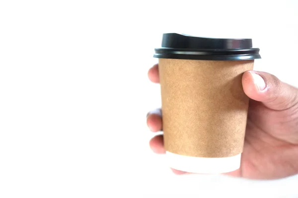 Brown paper cup and blank cap in hand with copy space — Stock Photo, Image