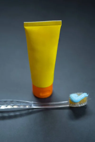 Toothpaste tube with toothbrush