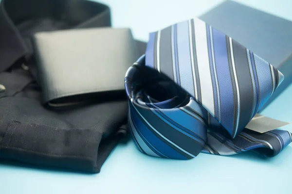 Blue necktie stripe and blue wallet on blue background