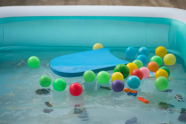 Many toy floating in outdoor swimming inflated pool. — Stock Photo, Image