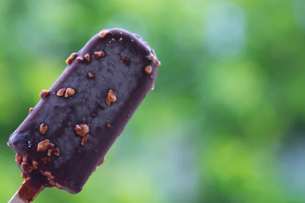 Tasty ice cream bar with chocolate and almonds