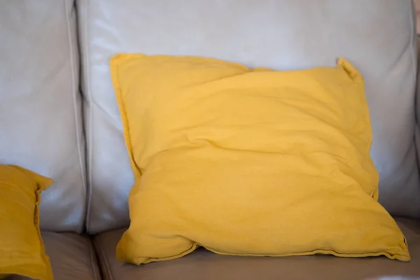 Yellow pillow on sofa in living room