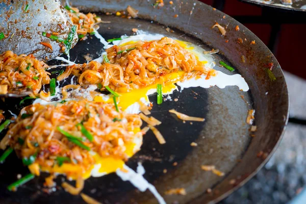 Cooking Thai fried noodles in hot pan.