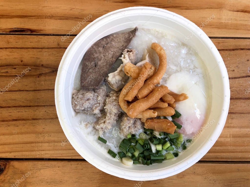 Traditional thai porridge rice gruel in white bowl congee.