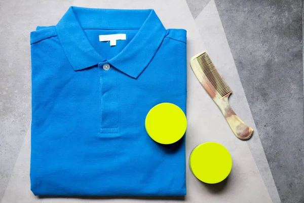 Hair wax and comb with blue shirt