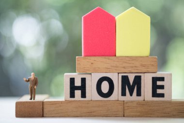 Minyatür insanlar Ev ahşap blok kelimeleri ile standı.