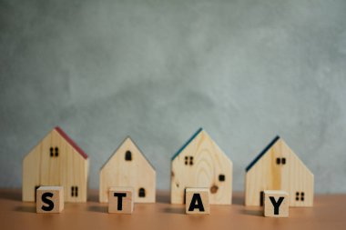 Sözlü ahşap ev. Güvenli yaşam için güvenli bir ev. Evde karantina kavramı, virüs salgınına karşı önleyici bir önlem ve hükümetin emrettiği sınırlama kavramı olarak kabul edilir.
