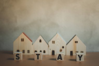 Sözlü ahşap ev. Güvenli yaşam için güvenli bir ev. Evde karantina kavramı, virüs salgınına karşı önleyici bir önlem ve hükümetin emrettiği sınırlama kavramı olarak kabul edilir.