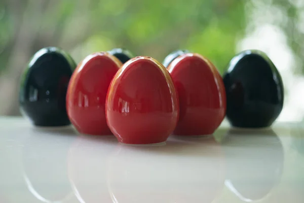 Group of red of egg shape ceramic shakers for salt and pepper