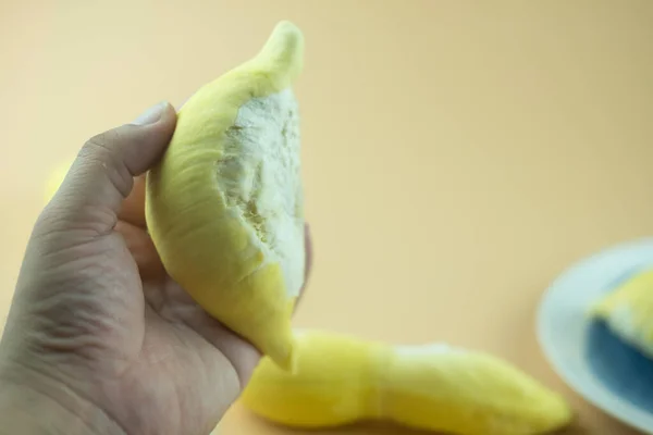 Tangan Memegang Durian Raja Buah Pada Latar Belakang Kuning — Stok Foto