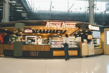Bangkok, Thailand - October 10, 2020 : Exterior view of Krispy Kreme Doughnut Shop at Suvarnabhumi airport Thailand clipart