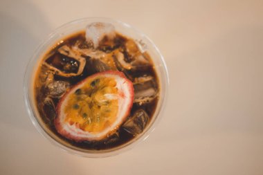 Buzlu portakal suyu ve çarkıfelek meyvesinin üst görüntüsü siyah soğuk kahve karışımı. Füzyon kahve ve yaz içeceği