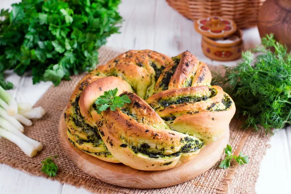 Garlic bread rolls with garlic, dill and herbs on the table