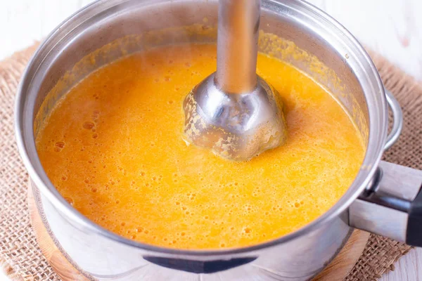 Pumpkin or carrot pureed for soup with blender — Stock Photo, Image