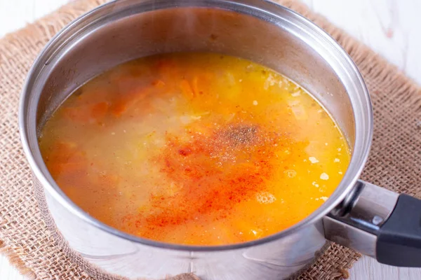 Pumpkin soup in a pan with spices on the table — Stock Image Pumpkin soup in a pan with spices on the table Stock Photo