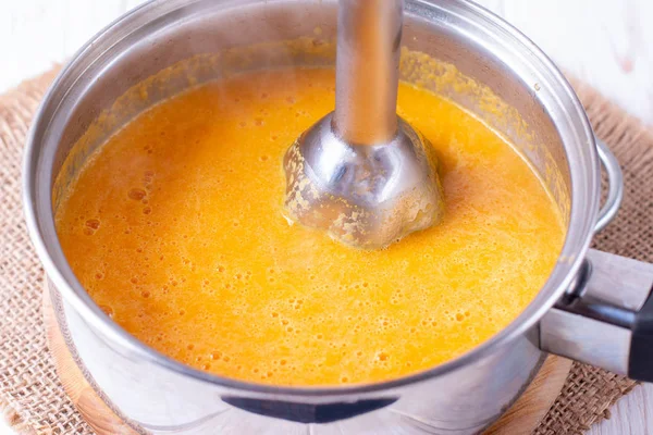 Pumpkin or carrot pureed for soup with blender — Stock Image Pumpkin or carrot pureed for soup with blender Royalty Free Stock Images