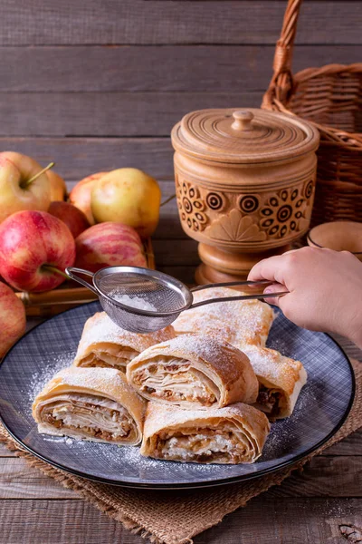 Pieces of apple homemade strudel with powdered sugar — Stock Photo, Image