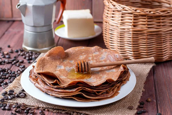 Thin chocolate pancakes on a white plate — Stock Photo, Image