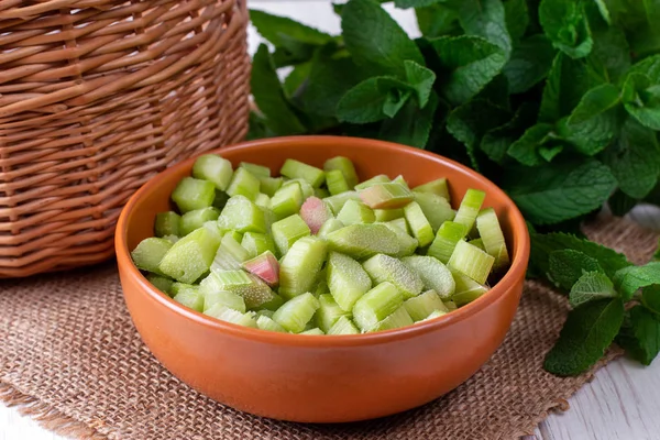 Frozen rhubarb in a plate on a white wooden table — Stock Photo, Image