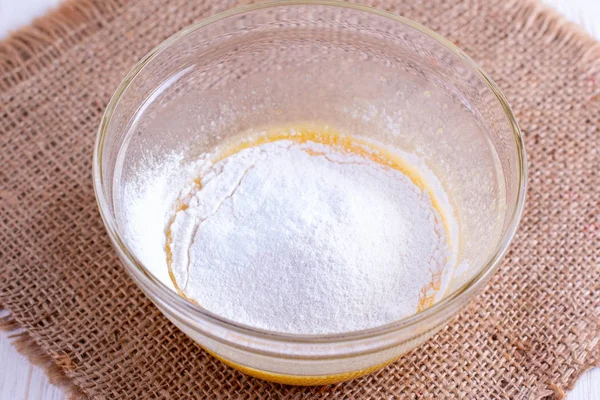 Flour in glass bowl on the wooden table — Stock Photo, Image