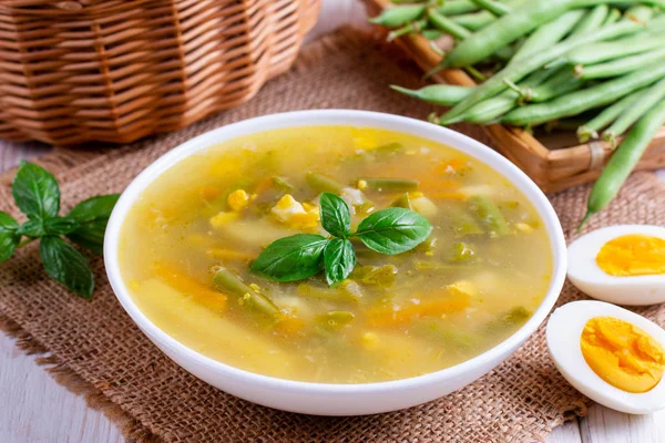 Fresh vegetable soup made of green bean, pea, carrot, potato in bowl — Stock Photo, Image