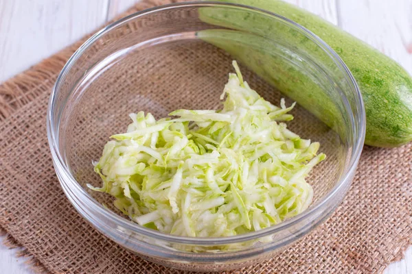 Grated zucchini in a glass bowl — Stock Photo, Image