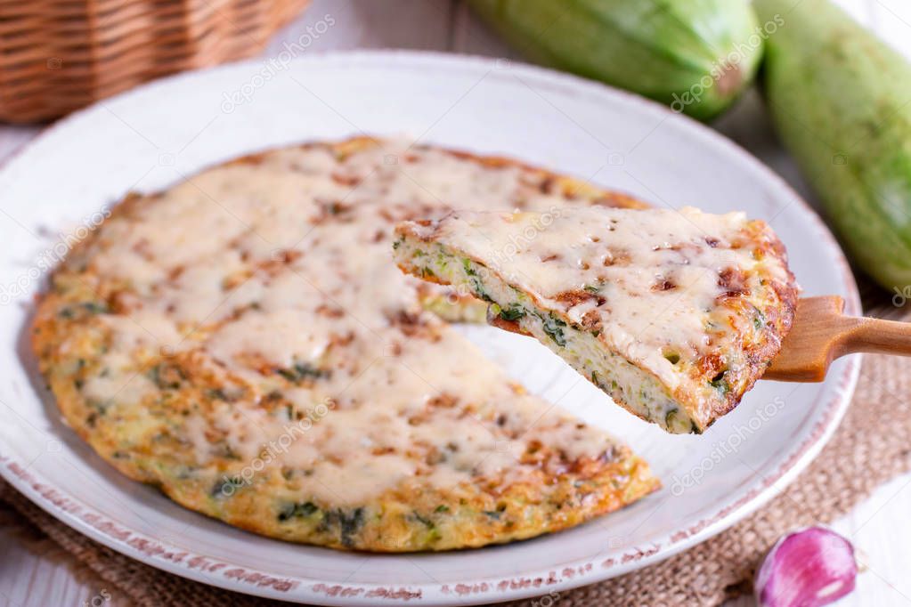 Homemade pie with zucchini, cheese and herbs