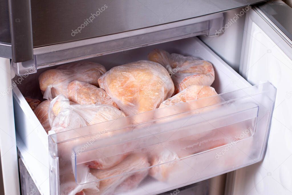 Frozen meat in bags on the freezer shelf. Frozen food