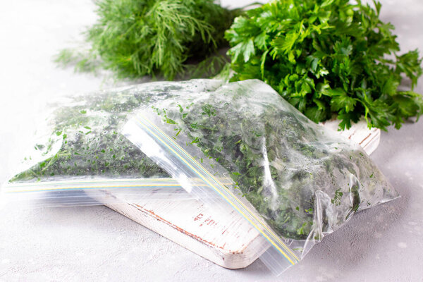Frozen Herbs (dill and parsley) in a plastic bag. Frozen vegetables. Concept of healthy eating.