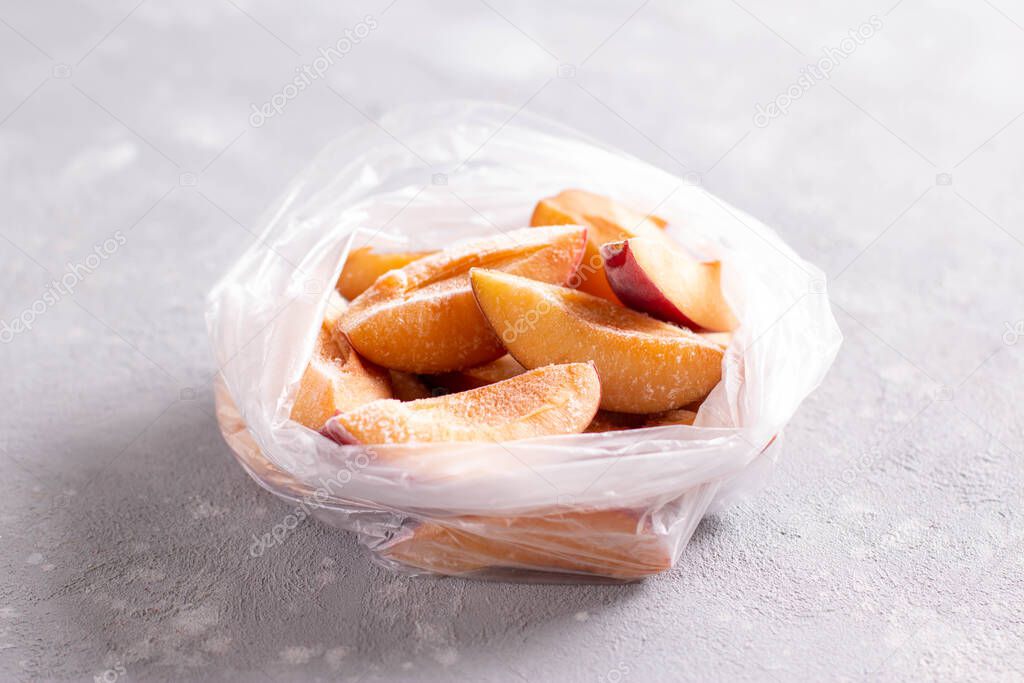 Frozen plums in a bag. Frozen fruits