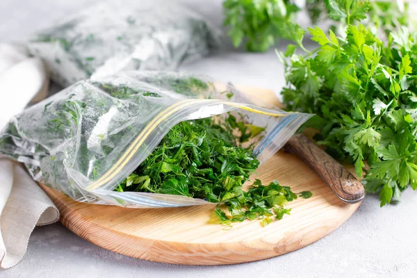 Frozen parsley in a plastic bag. Frozen vegetables. Concept of healthy eating.