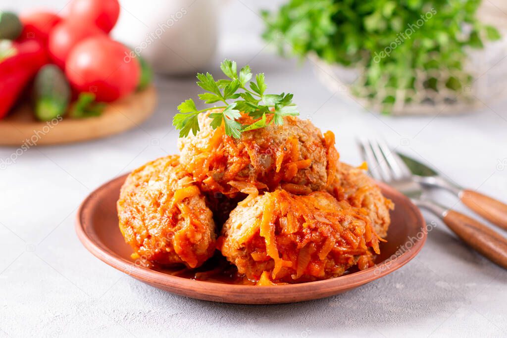 Meatballs with cabbage. Lazy cabbage rolls with vegetables on concrete background
