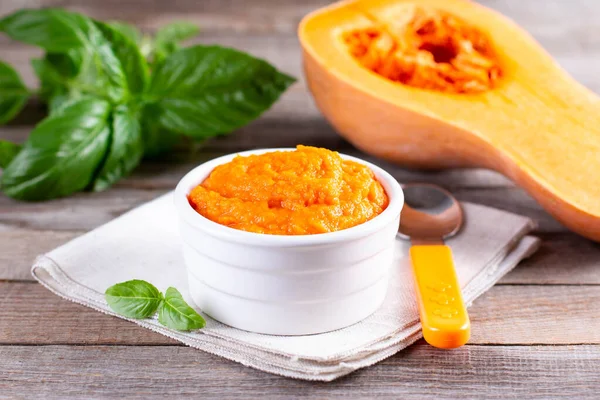 Pumpkin puree in white ceramic cup on wooden background. Dietary dish. Baby food. — Stock Image Pumpkin Puree White Ceramic Cup Wooden Background Dietary Dish Baby Royalty Free Stock Photos