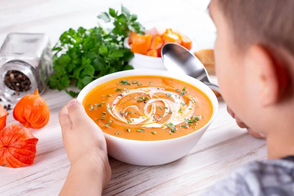 Young boy eating pumpkin soup — Stock Image Young Boy Eating Pumpkin Soup Stock Image