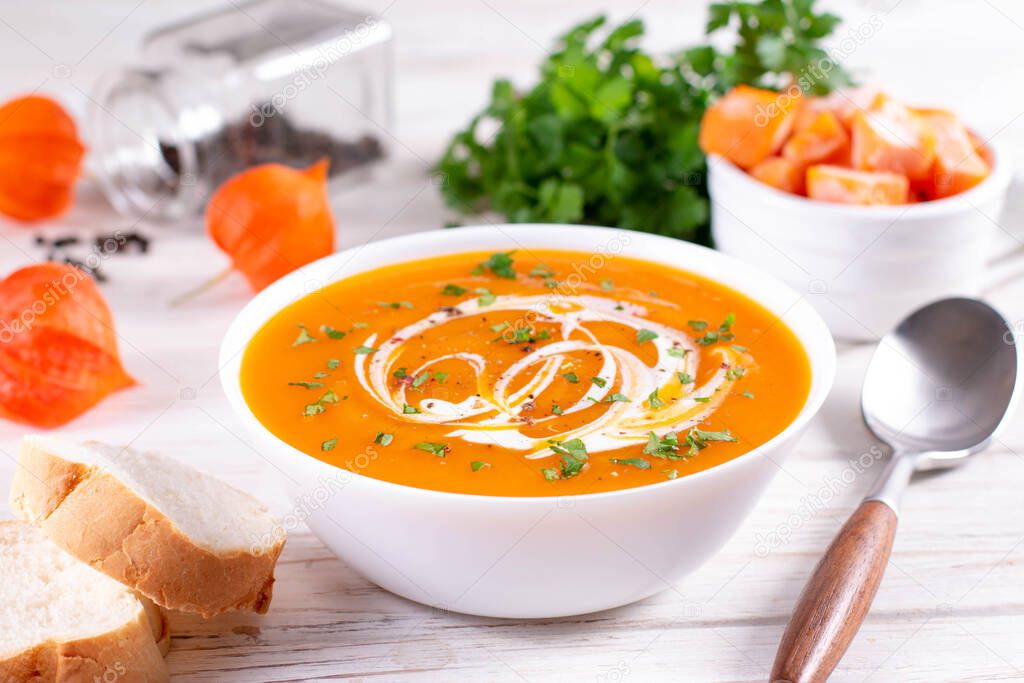 Healthy comfort pumpkin, butternut squash soup in white bowl. Close up. Autumn Winter food