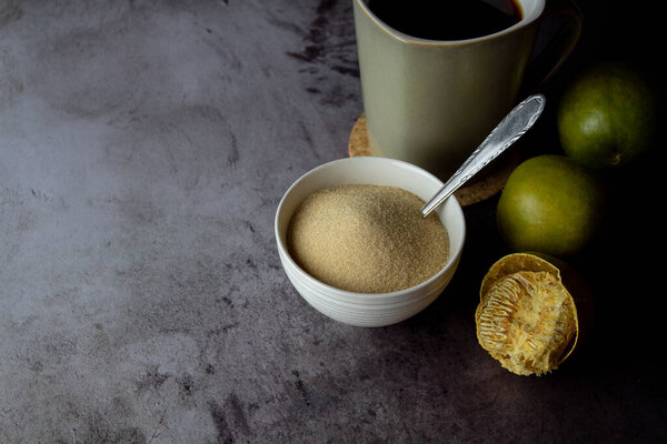 dried monk fruit, luo han guo, and monk fruit sugar crystals accompanied with a cup of tea or coffee