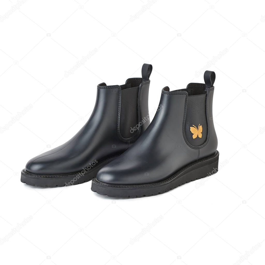 Women black chelsea boots with golden detail. Isolated on white background