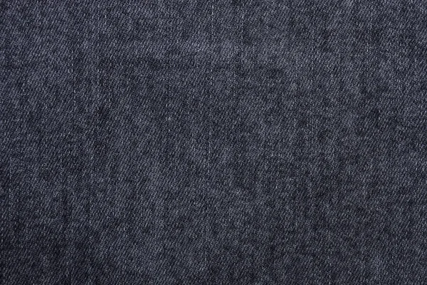 Black or dark gray jeans texture as background. Top view