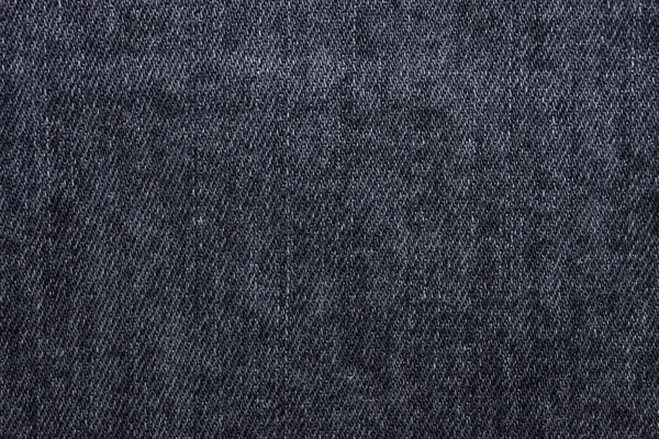 Black or dark gray jeans texture as background. Top view