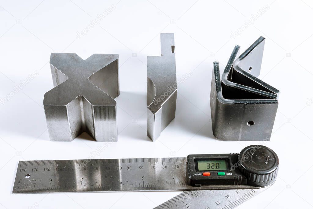 Sheet metal bending tool and equipment isolated on a white background. Special Bending machine Forming mold punch and die. Press brake tools, bend tools, press brake punch and die. Digital protractor.