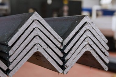 Yuvarlanmış metal, L-profil. Fabrikada çelik yığını var..