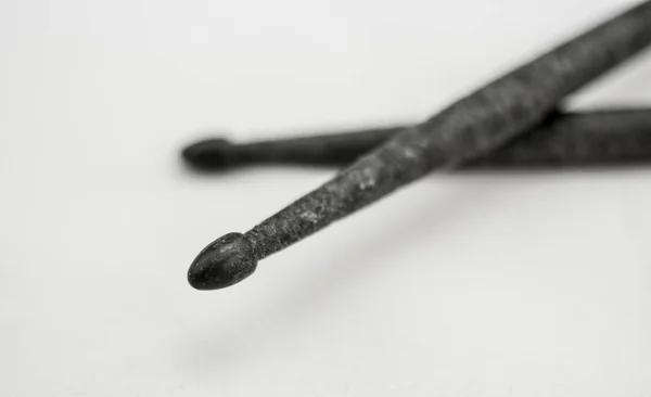 Carbon drumsticks in the foreground with wear detail — Stock Photo, Image