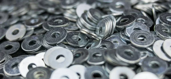 Set of metal and shiny washers in the foreground — Stock Photo, Image